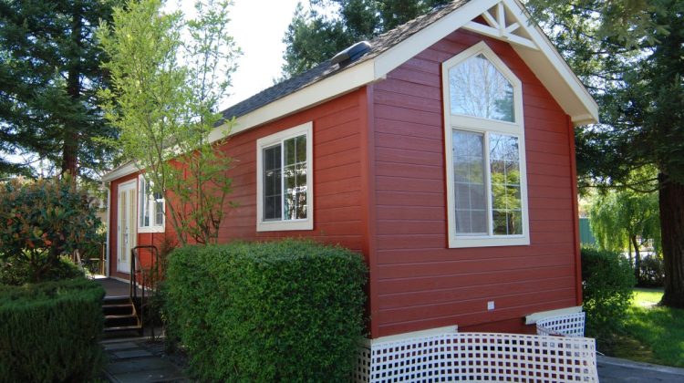 tiny home cost for small, tiny red house situated amongst trees