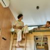 couple having morning coffee in tiny home loft bedroom